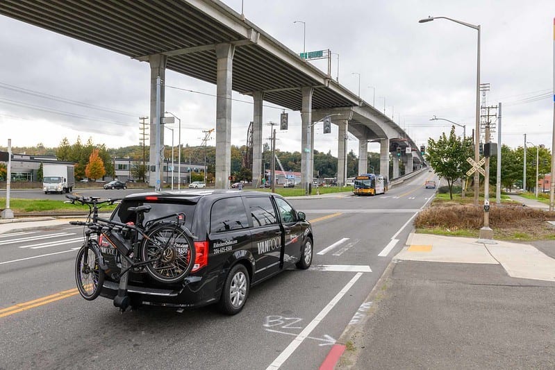 King county metro vanpool with bicycle on a rack on the back, driving towards West Seattle low bridge