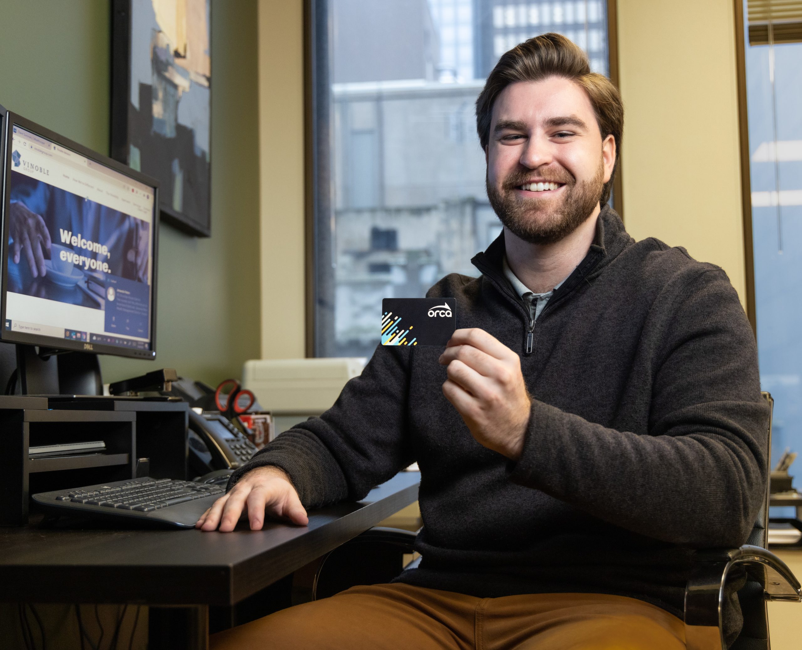 Employee Holding ORCA Card