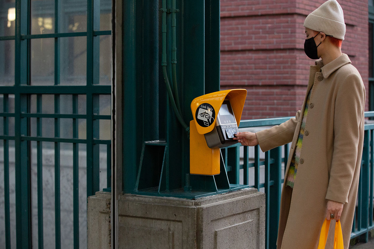 Person tapping their ORCA card at a light rail station